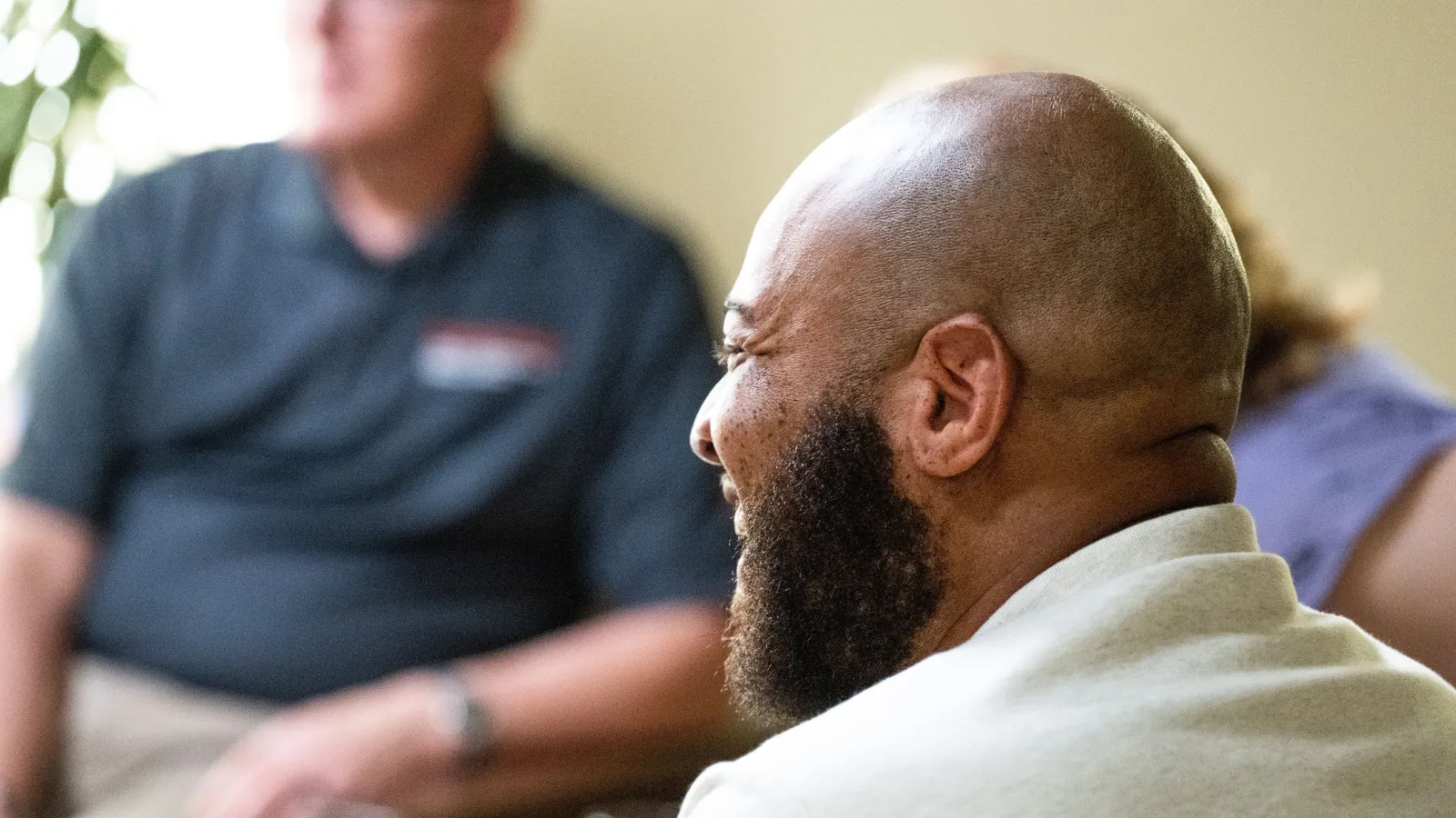 Side profile shot of veteran, Romaine Byrd, smiling on set. 