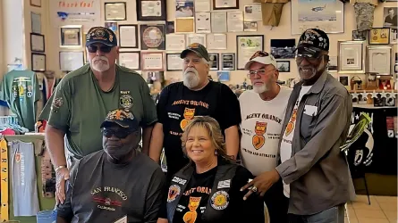 Robin Spence (front, middle) smiling with veterans awarded Orange Medals 